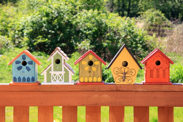 Collection of colorful wooden birdhouses.